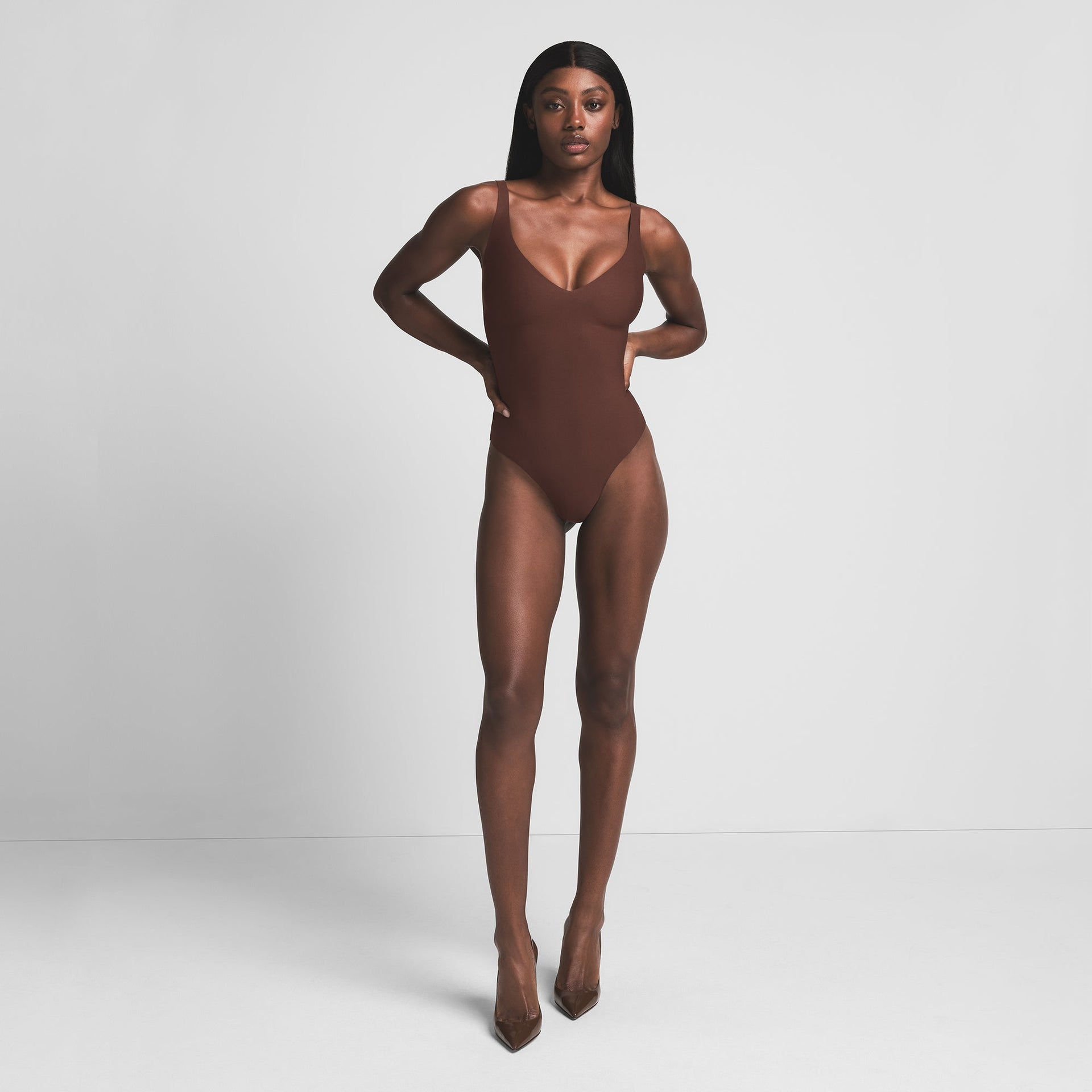 SKIMS BODY UNLINED PLUNGE THONG BODYSUIT | COCOA