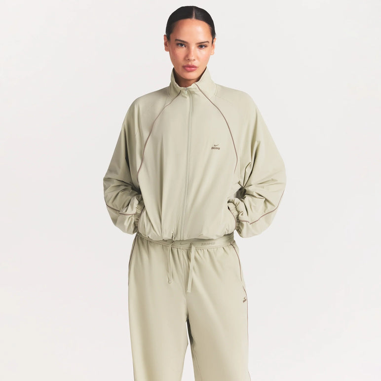 NikeSKIMS STRETCH NYLON OVERSIZED TRACK JACKET | TALC